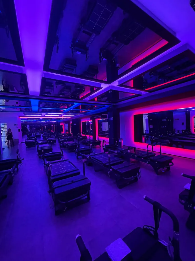 Gym with scenic purple and pink LED lighting on the ceiling and walls