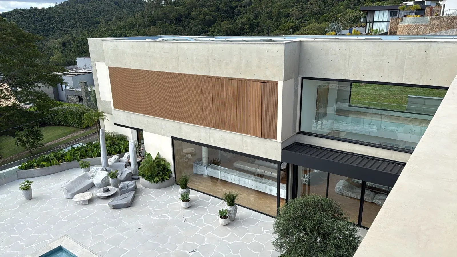 Aerial view of a contemporary house with terrace, deck and greenery